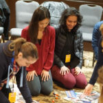 Group of Stack Overflow employees at a company meeting, highlighting the collaborative environment and the diverse team.