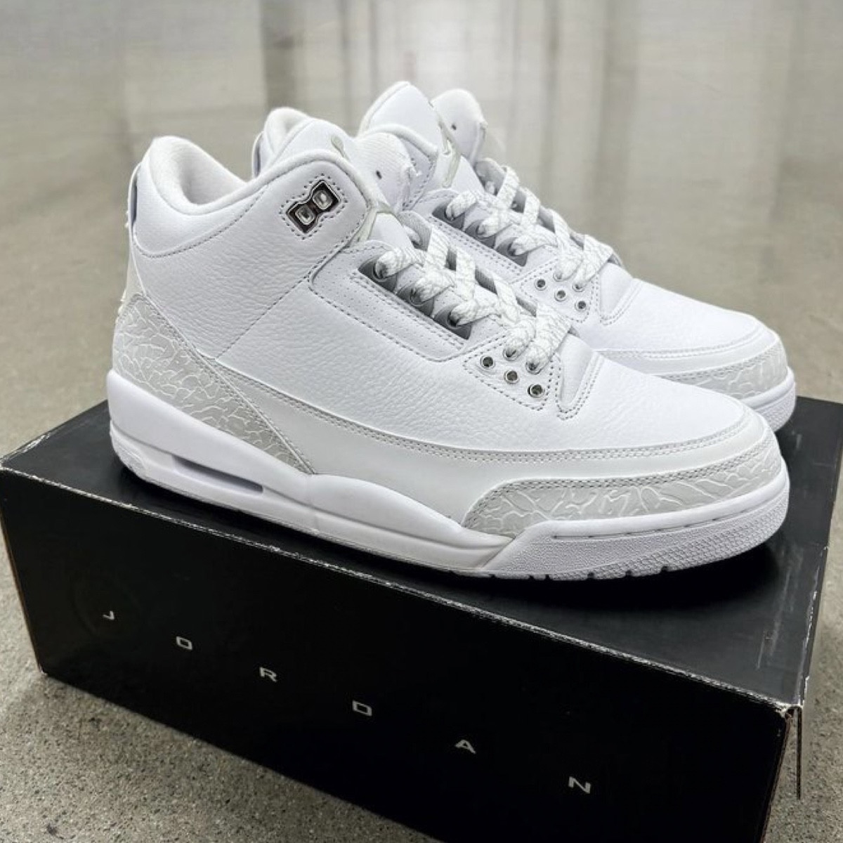 Side profile view of the Air Jordan 3 Pure Money 2025, highlighting the white tumbled leather and metallic silver accents.