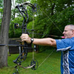 Bowhunter drawing a Bear Alaskan XT compound bow during testing