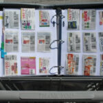 Zippered coupon binder organizer with handle, showcasing organized coupons and dividers.