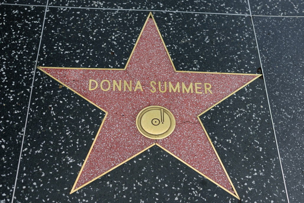 Donna Summer, a successful artist who made her hard work visible, with her star on the Hollywood Walk of Fame, illustrating the importance of recognition and visibility in career success.