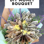 A finished money bouquet wrapped in brown paper and tied with a ribbon.