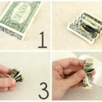 Stack of crisp dollar bills being gathered for a DIY money lei project.