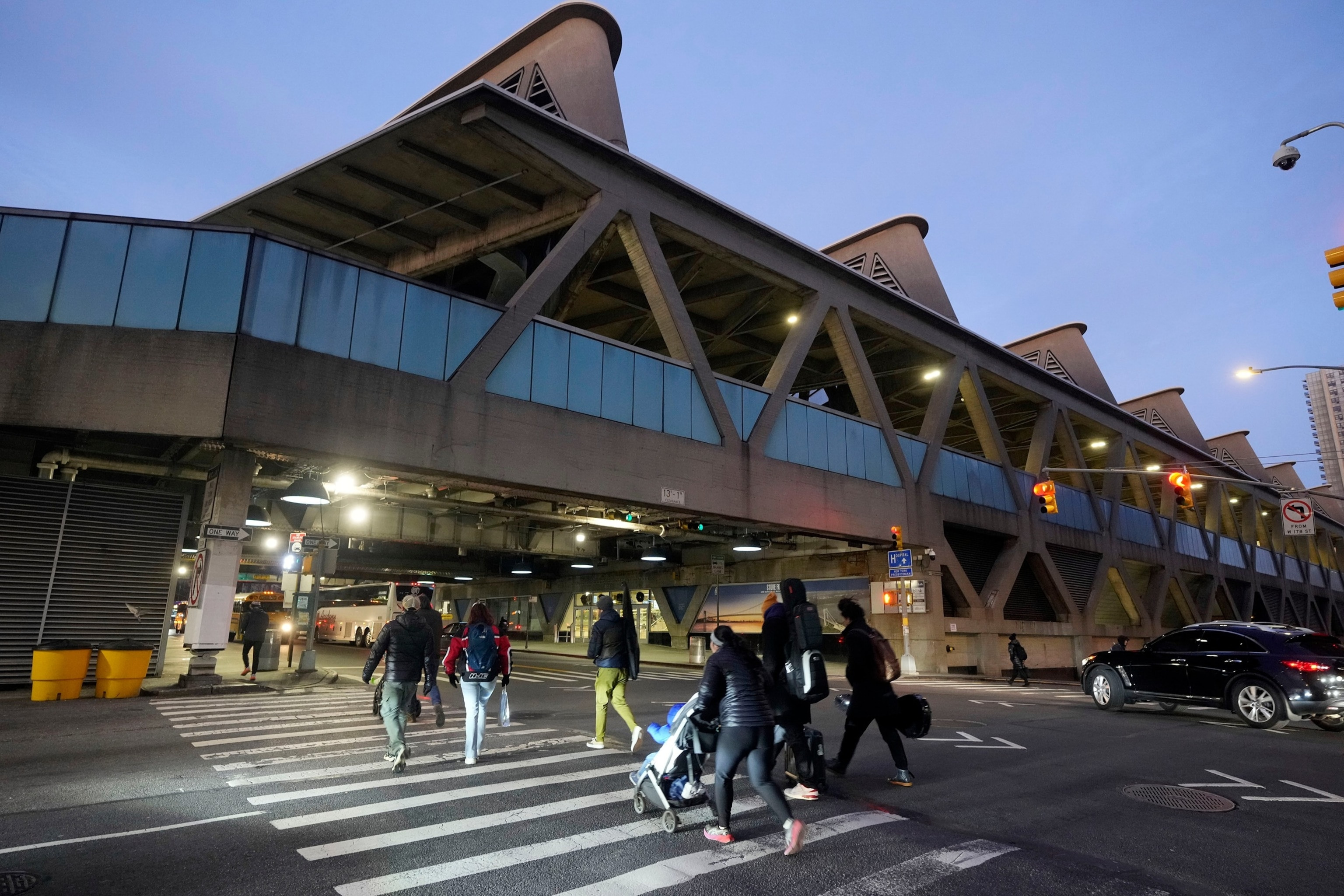 Pedestrians outside the George Washington Bridge Bus Station in New York, a location linked to the suspect's movements after the shooting.