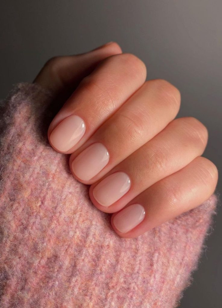 Sheer pink old money nails on short natural nails, healthy and glossy finish.