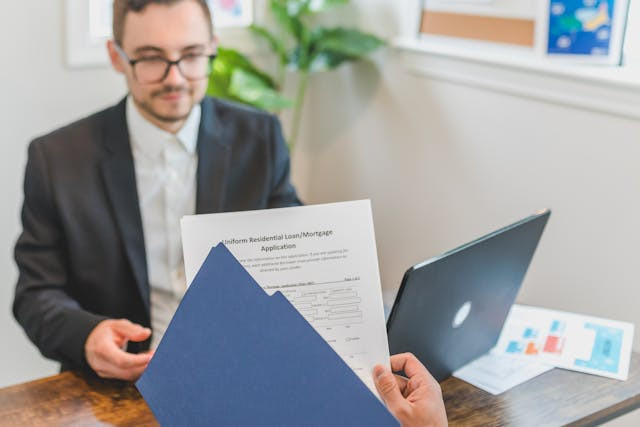 person holding loan documents