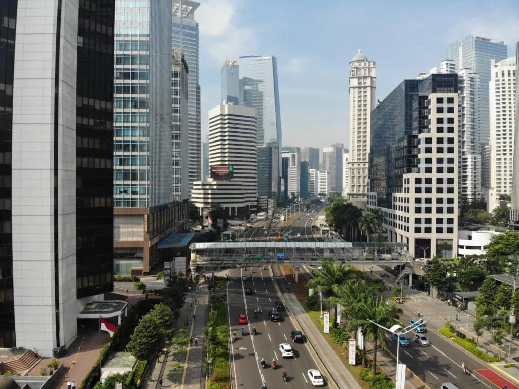 A cityscape featuring buildings and roads, symbolizing the urban environment where Indonesian Rupiah is used daily in transactions and economic activities.