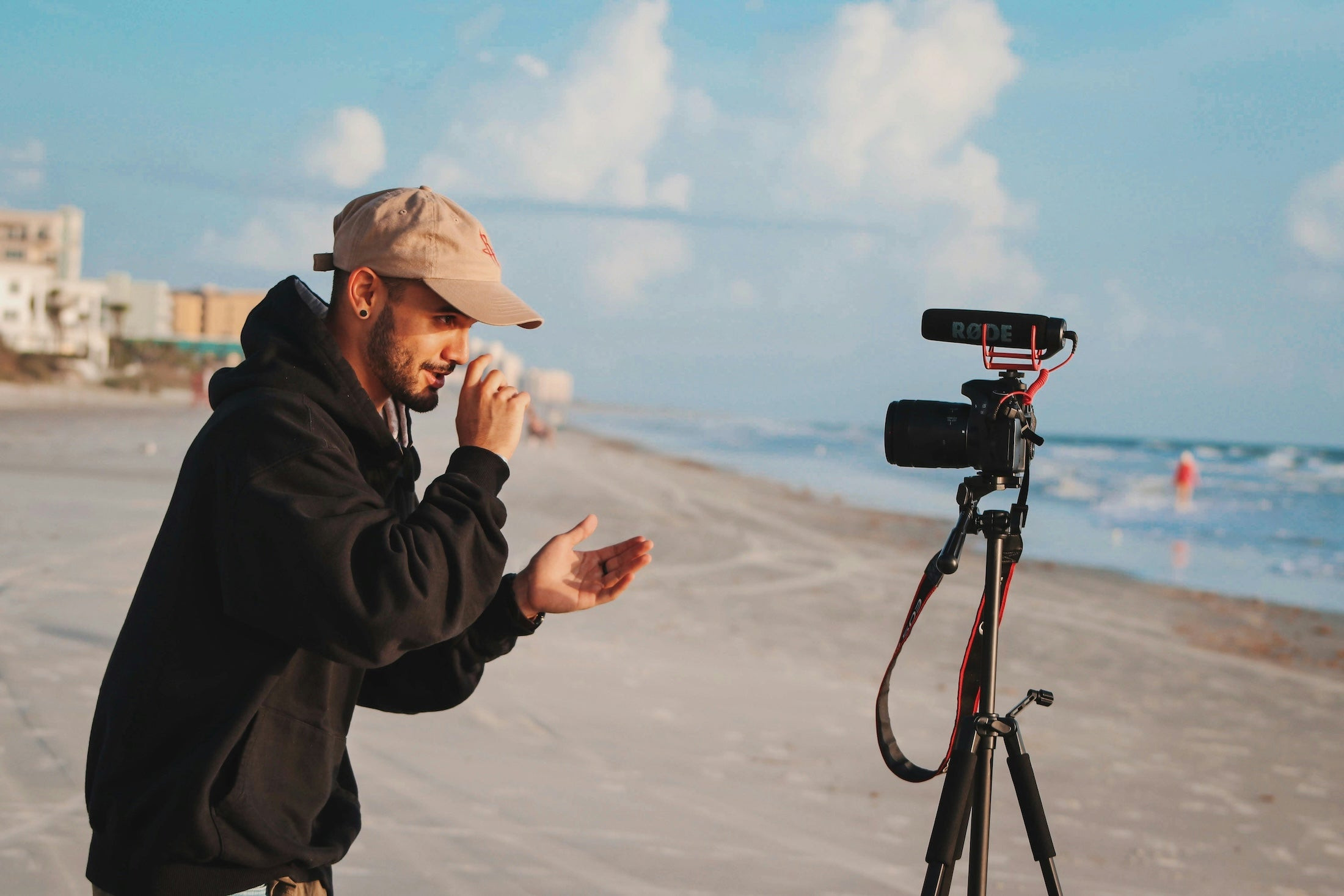 Person talking to a camera on the beach