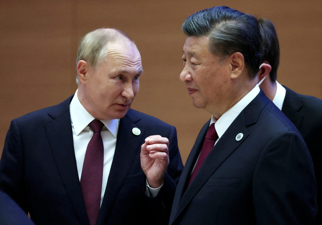 Russian President Vladimir Putin speaks with Chinese President Xi Jinping before an extended-format meeting of heads of the Shanghai Cooperation Organization summit (SCO) member states in Samarkand, Uzbekistan September 16, 2022, illustrating the financial partnership between Russia and China.