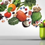 Supplement capsule open with fruits and vegetables emerging, vitamins and minerals, micronutrient