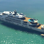 A player obtaining weapons from another player's yacht, showcasing early access to advanced weaponry