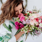 Woman smelling beautiful bouquet of wedding flowers