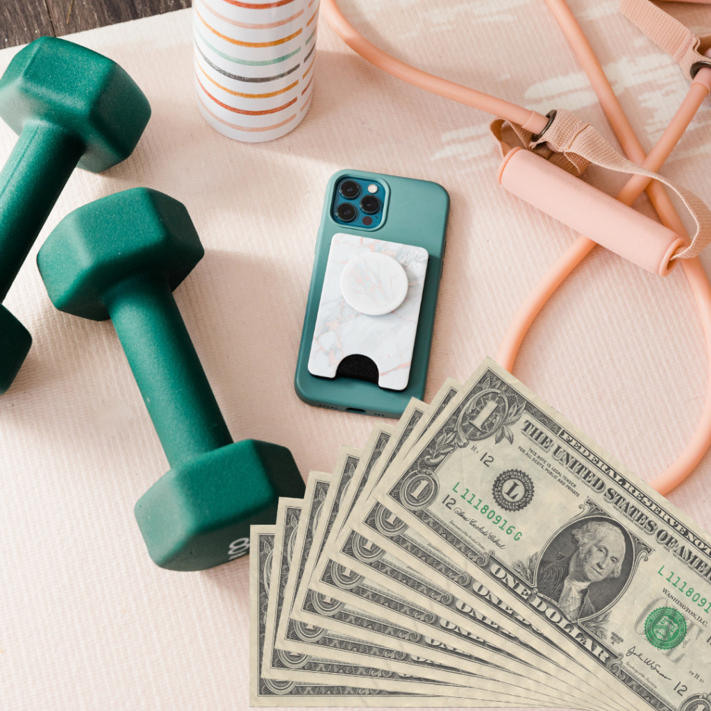Equipment useful in fitness and dollar banknotes - fitness programs bring money! Source: Canva