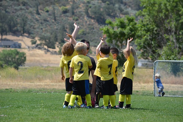 Students playing soccer outdoors