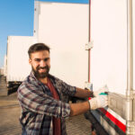 Smiling truck driver wearing gloves