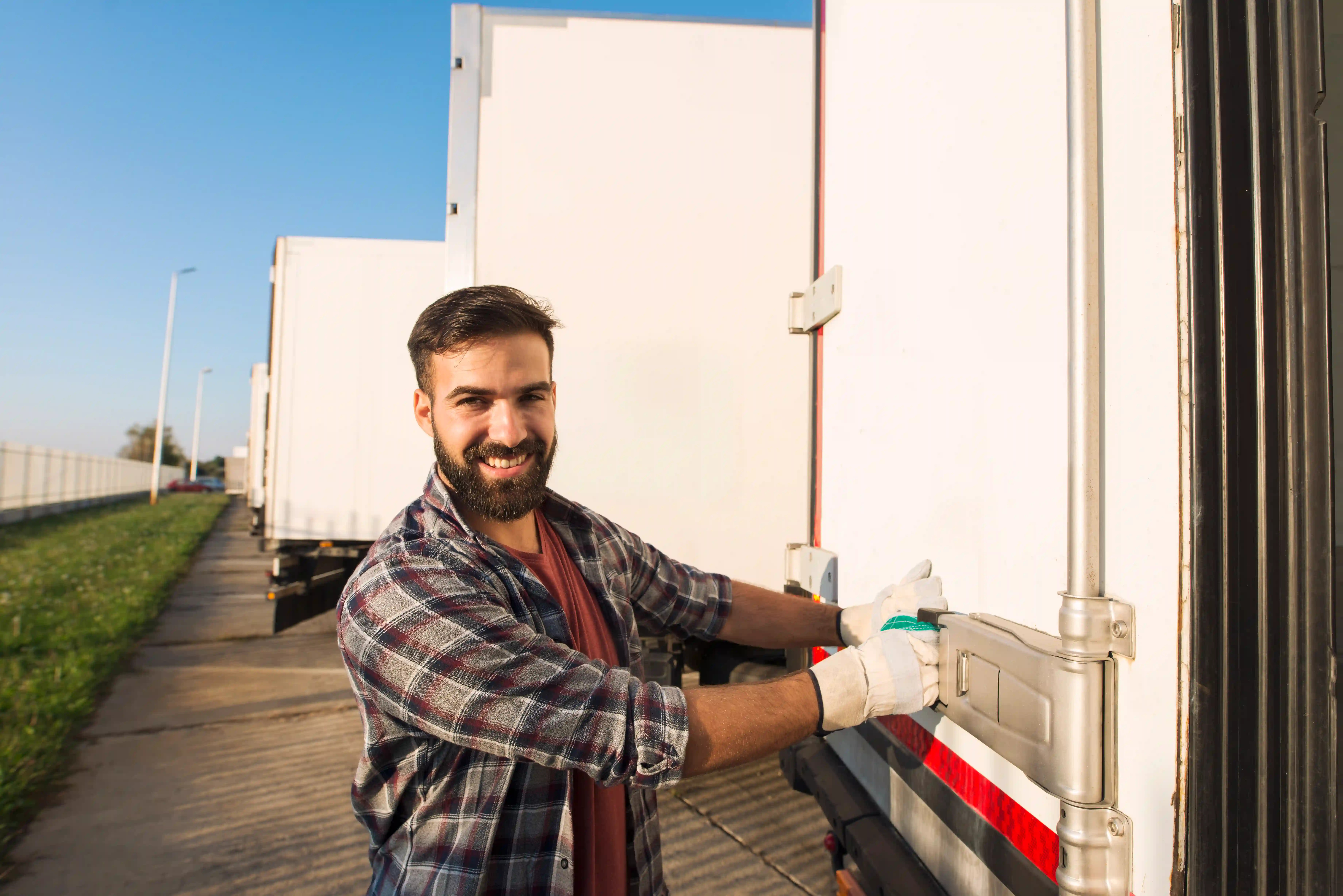 Smiling truck driver wearing gloves