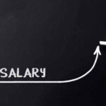 A chalkboard displaying the word Salary and an upward trending arrow, signifying potential wage growth