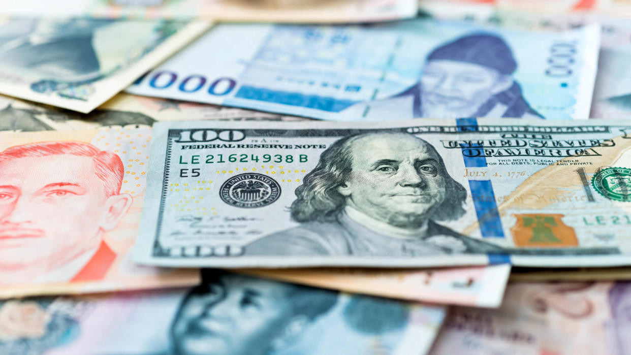 Coins and paper money representing global currency holdings