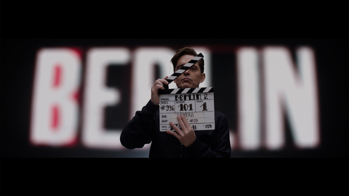 Pedro Alonso using a film clapboard during the filming of Berlin