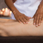 Hands of beauty therapist doing massage to woman in spa