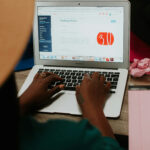 Person creating an online challenge on a laptop