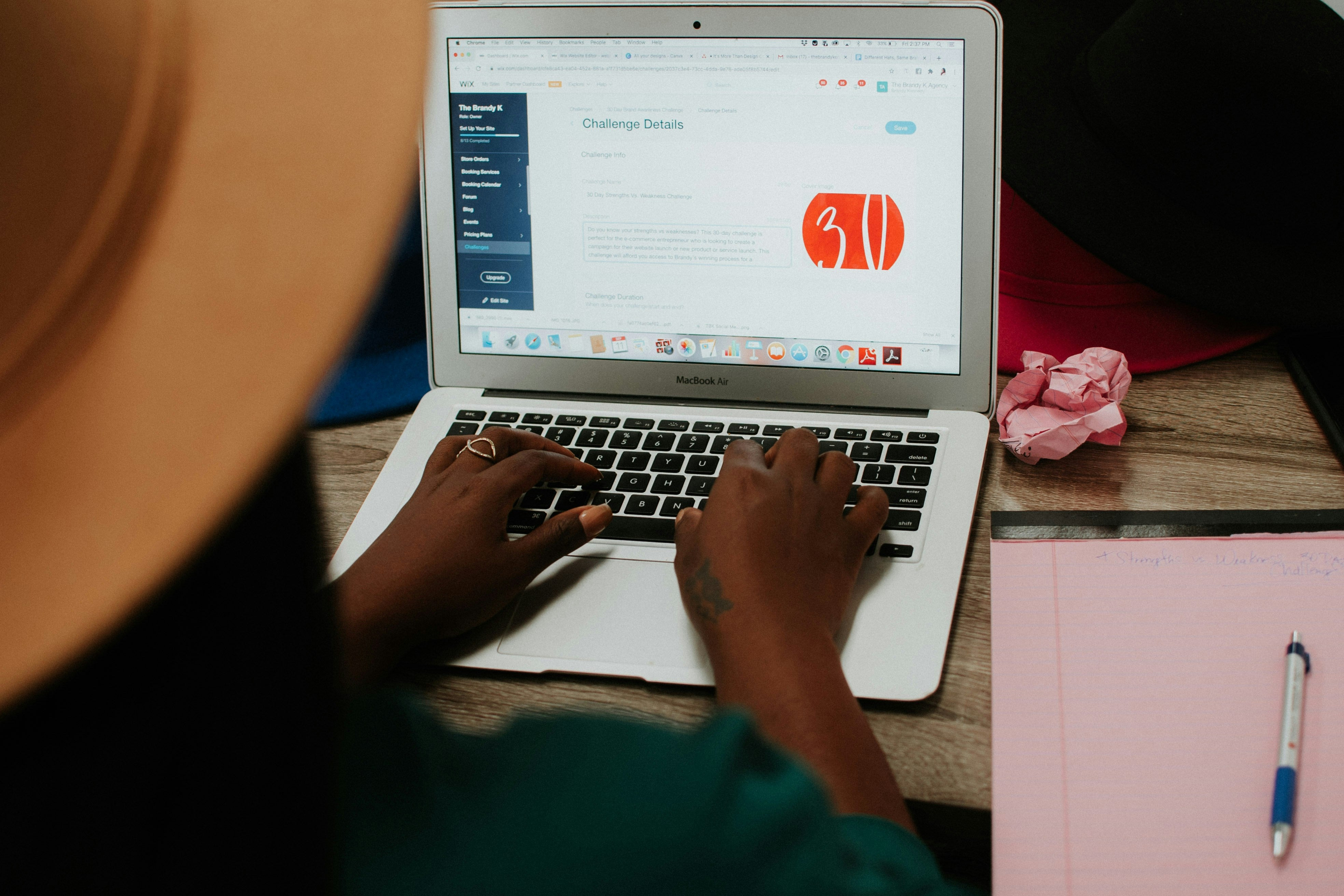 Person creating an online challenge on a laptop