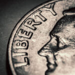 Close up of an 1894-S Barber Dime on a neutral surface, showcasing its details and condition.