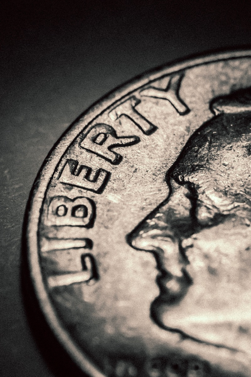 Close up of an 1894-S Barber Dime on a neutral surface, showcasing its details and condition.