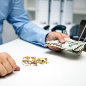 Pawn shop employee assisting customer with loan