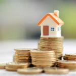 house fixture on top of stack of coins