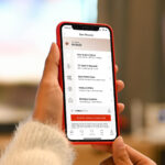 Woman looking at Macy's Star Rewards Tracking App on her phone