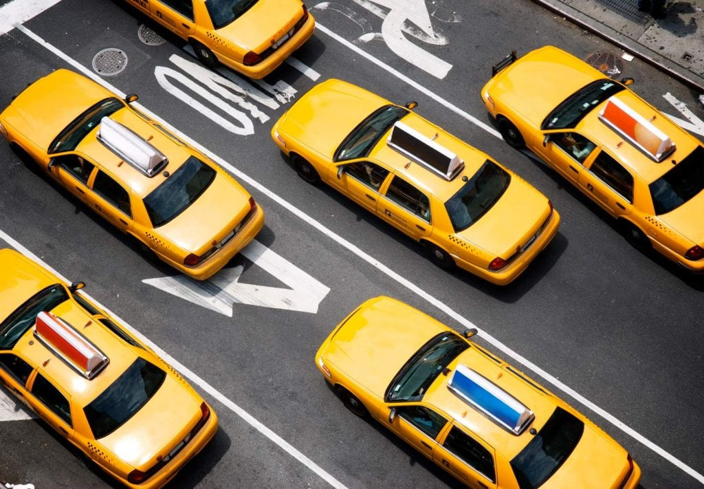 A picture of several yellow cabs driving through NYC begs the question,
