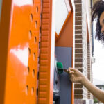A woman using an ATM to withdraw money, highlighting the convenience of accessing funds.