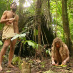 Naked and Afraid contestants in a challenging environment