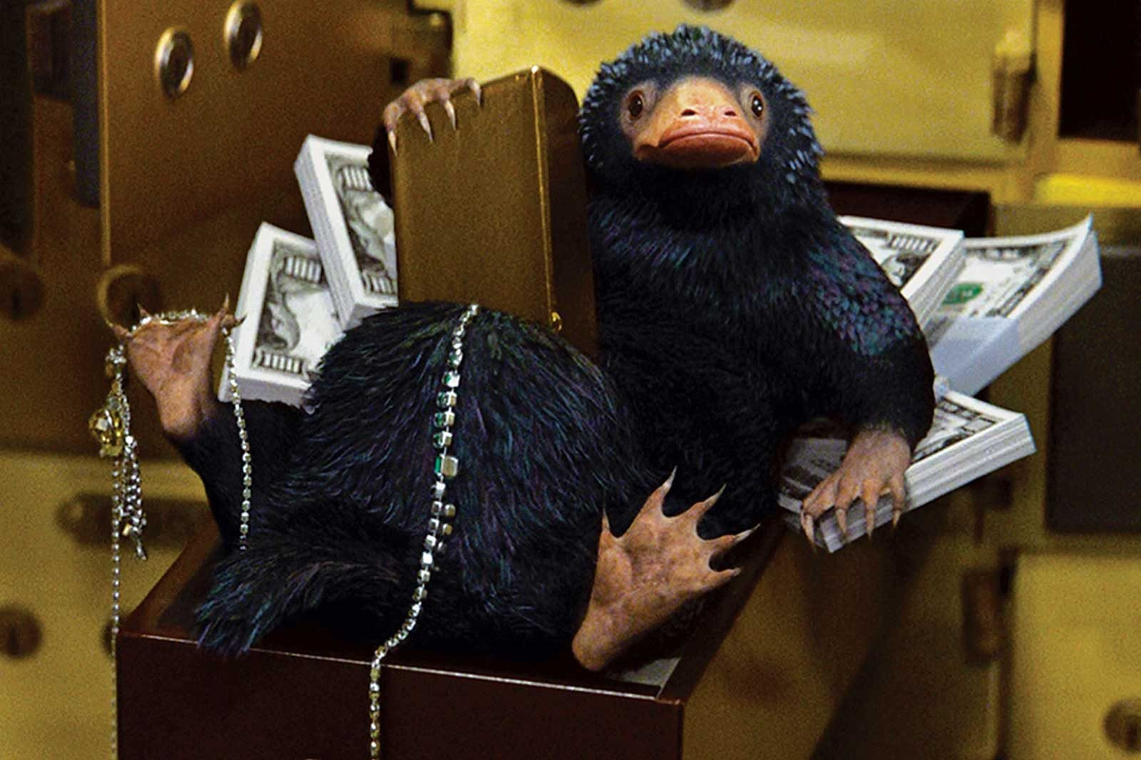 Niffler on a pile of money in Hogwarts Legacy, symbolizing wealth accumulation