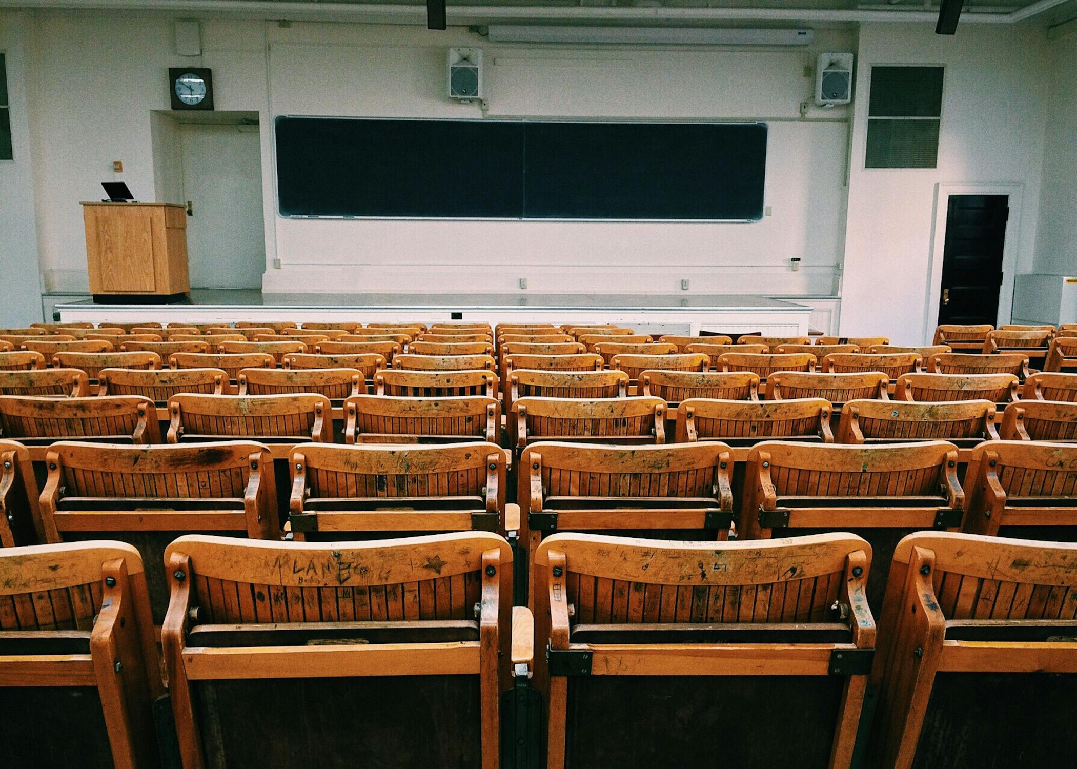 Teacher with students in a classroom, emphasizing the rewards of teaching