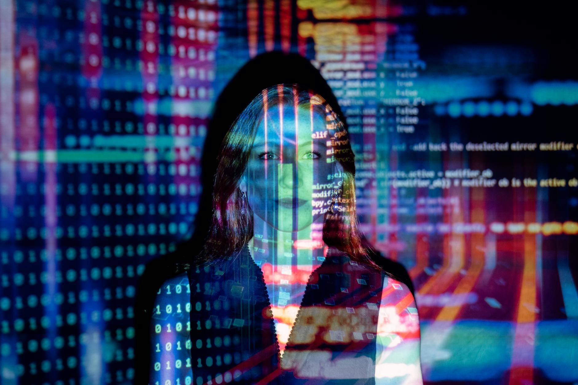 Person working remotely at a desk with multiple screens, symbolizing online services.