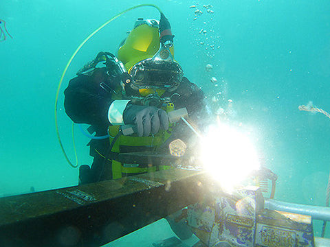 Underwater welder working on a submerged structure, highlighting the technical skills required for the job