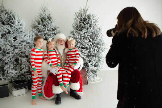 Setting up the Christmas Wonderland scene for Santa photo sessions, focusing on creating an enchanting environment