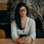 Person holding a smartphone with a money-related app