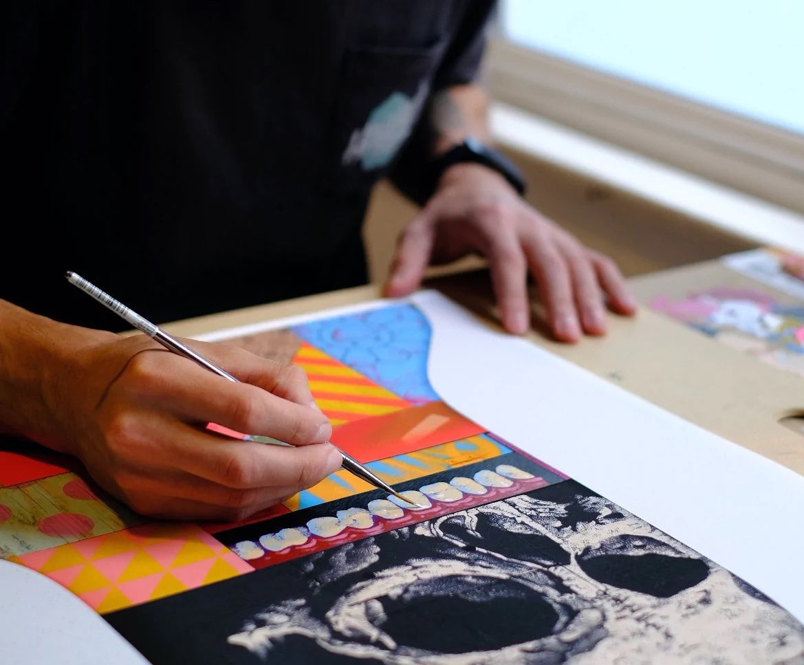 An artist works on a graphic 2D art project on a table
