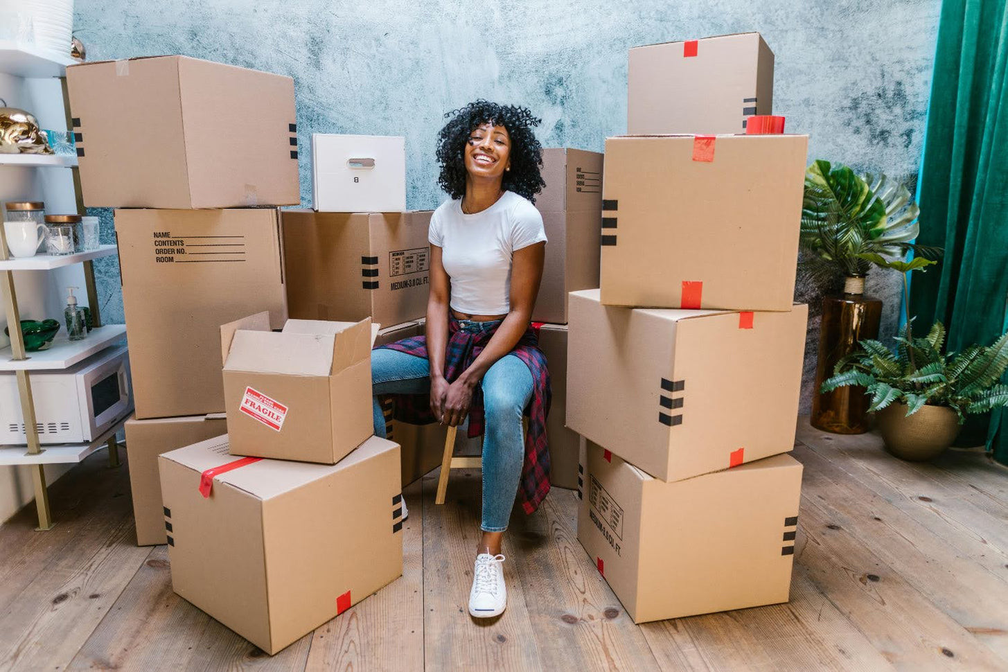 Woman amidst shipping boxes, illustrating dropshipping
