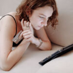 Woman tracks spending in budgeting app on phone