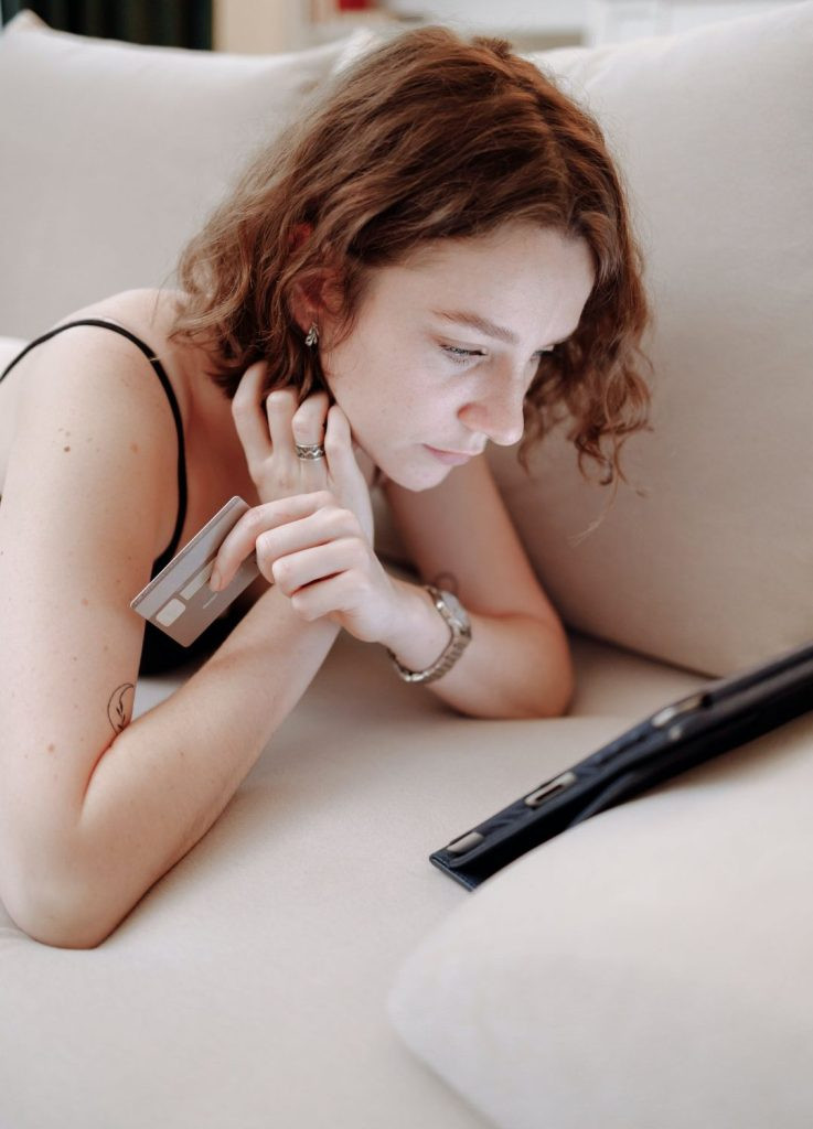 Woman tracks spending in budgeting app on phone