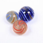 Close-up of several Lutz marbles with shimmering metallic flecks